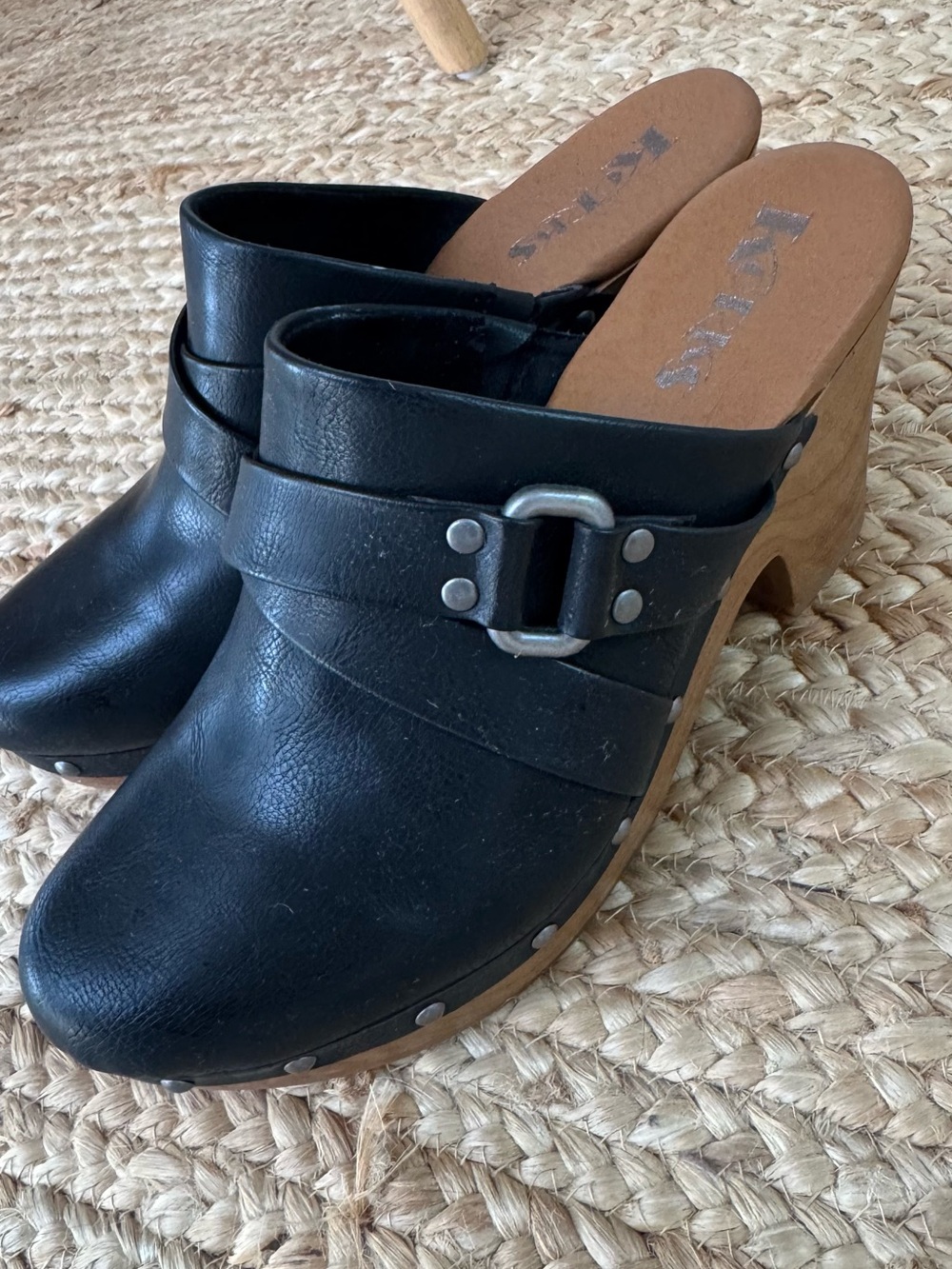 Korks Black Leather Clog Mules with Buckle Detail